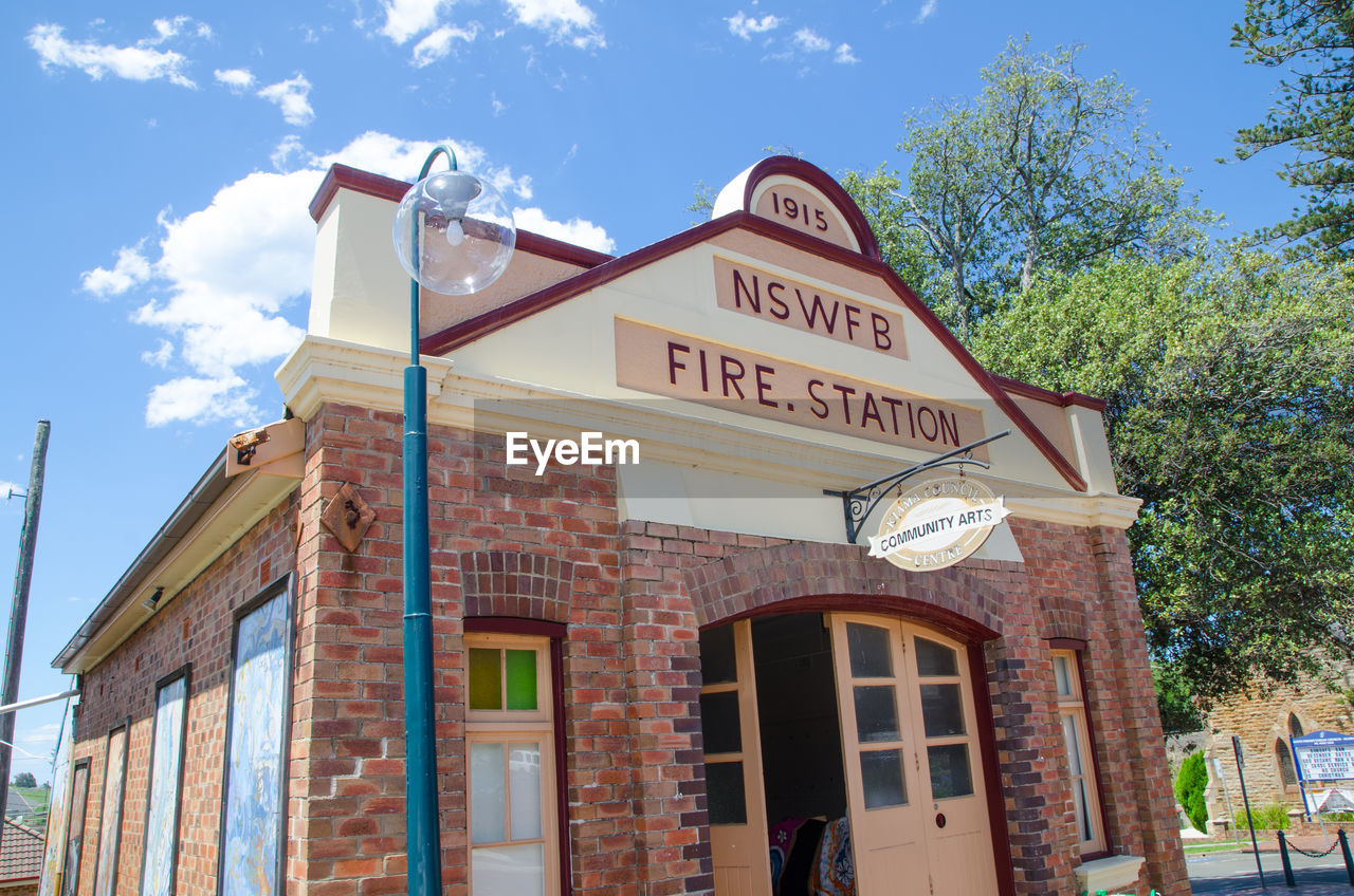 LOW ANGLE VIEW OF INFORMATION SIGN AGAINST SKY