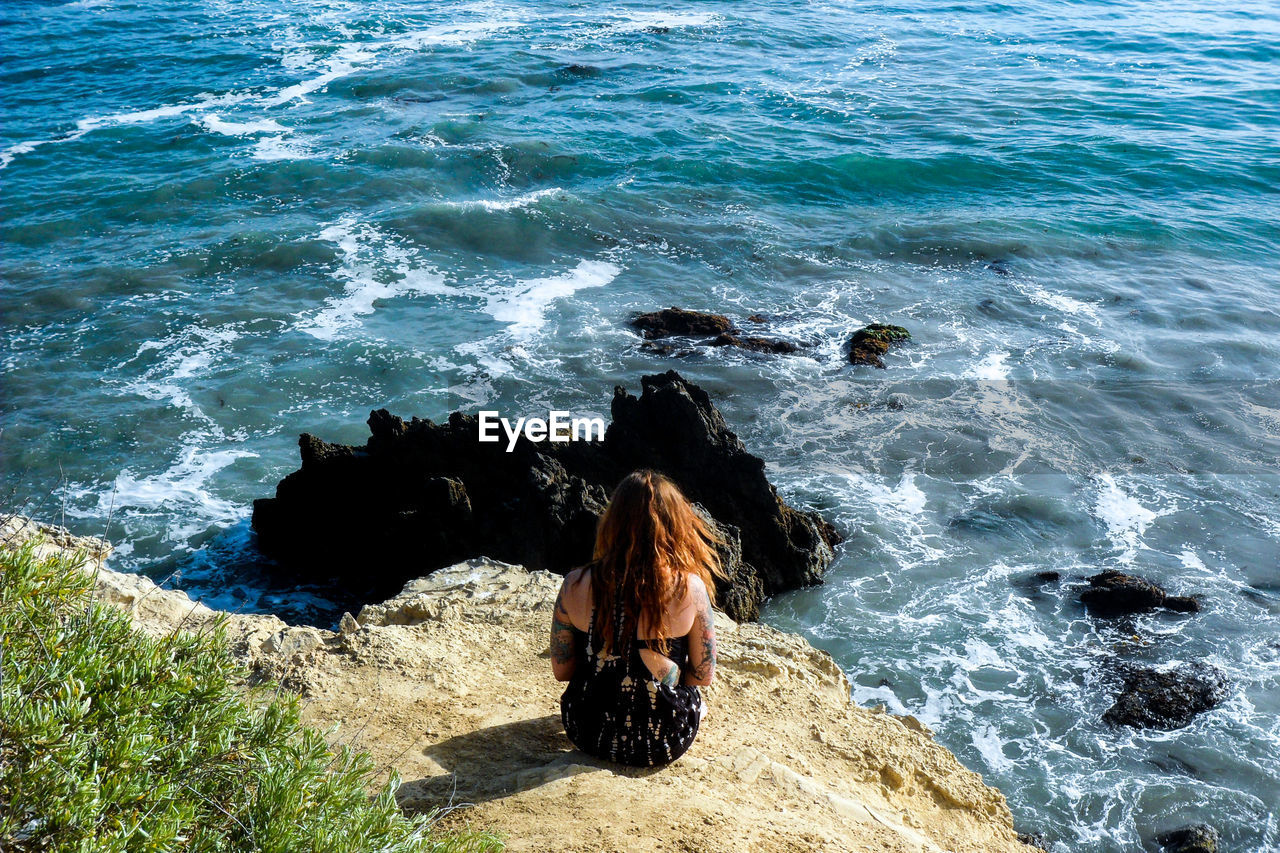 Lonely girl looking at sea in orange county california 
