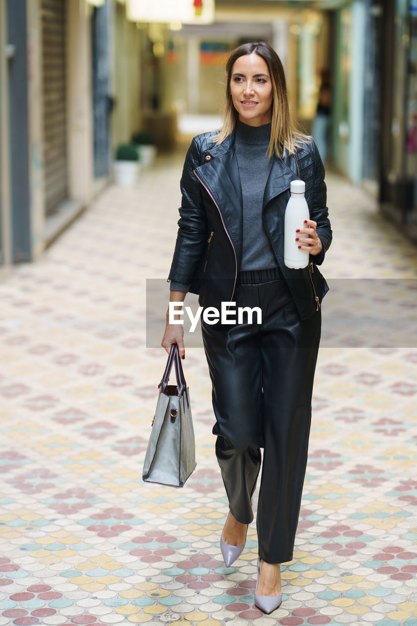 portrait of young woman standing on street