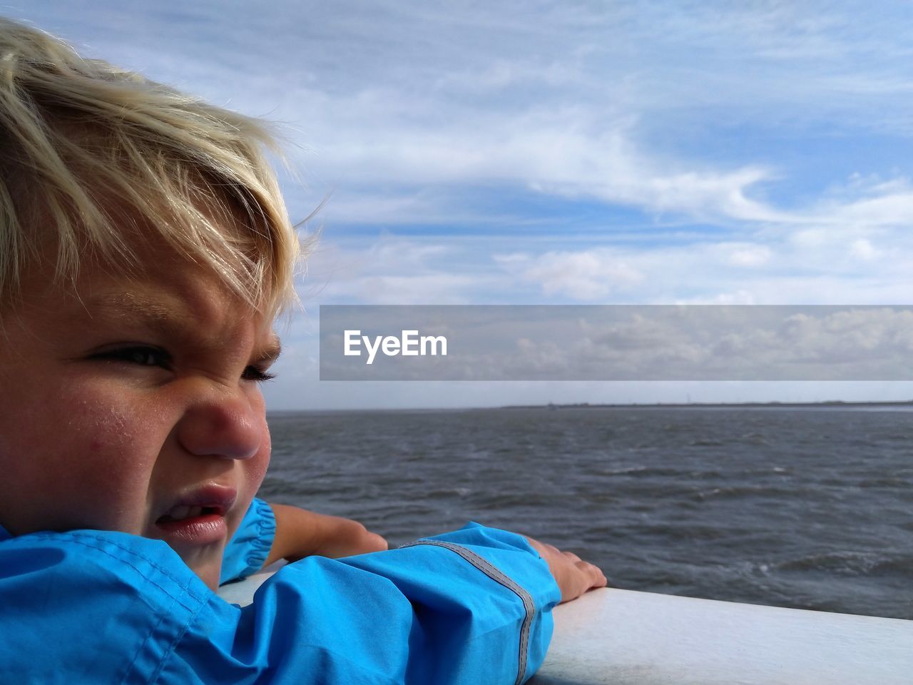 water, sea, one person, blue, child, childhood, portrait, sky, headshot, men, cloud, blond hair, vacation, nature, emotion, trip, day, leisure activity, holiday, horizon, person, beach, looking, outdoors, horizon over water, toddler, land, beauty in nature, travel, casual clothing