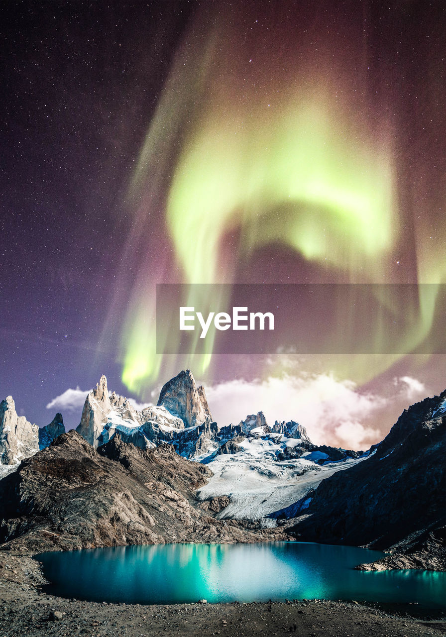 Scenic view of snowcapped mountains against sky at night