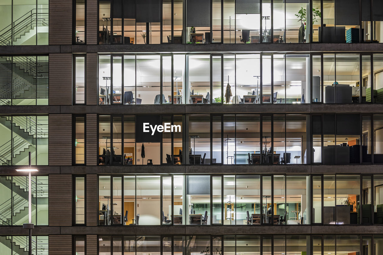 Germany, baden-wurttemberg, stuttgart, exterior of illuminated office building at night