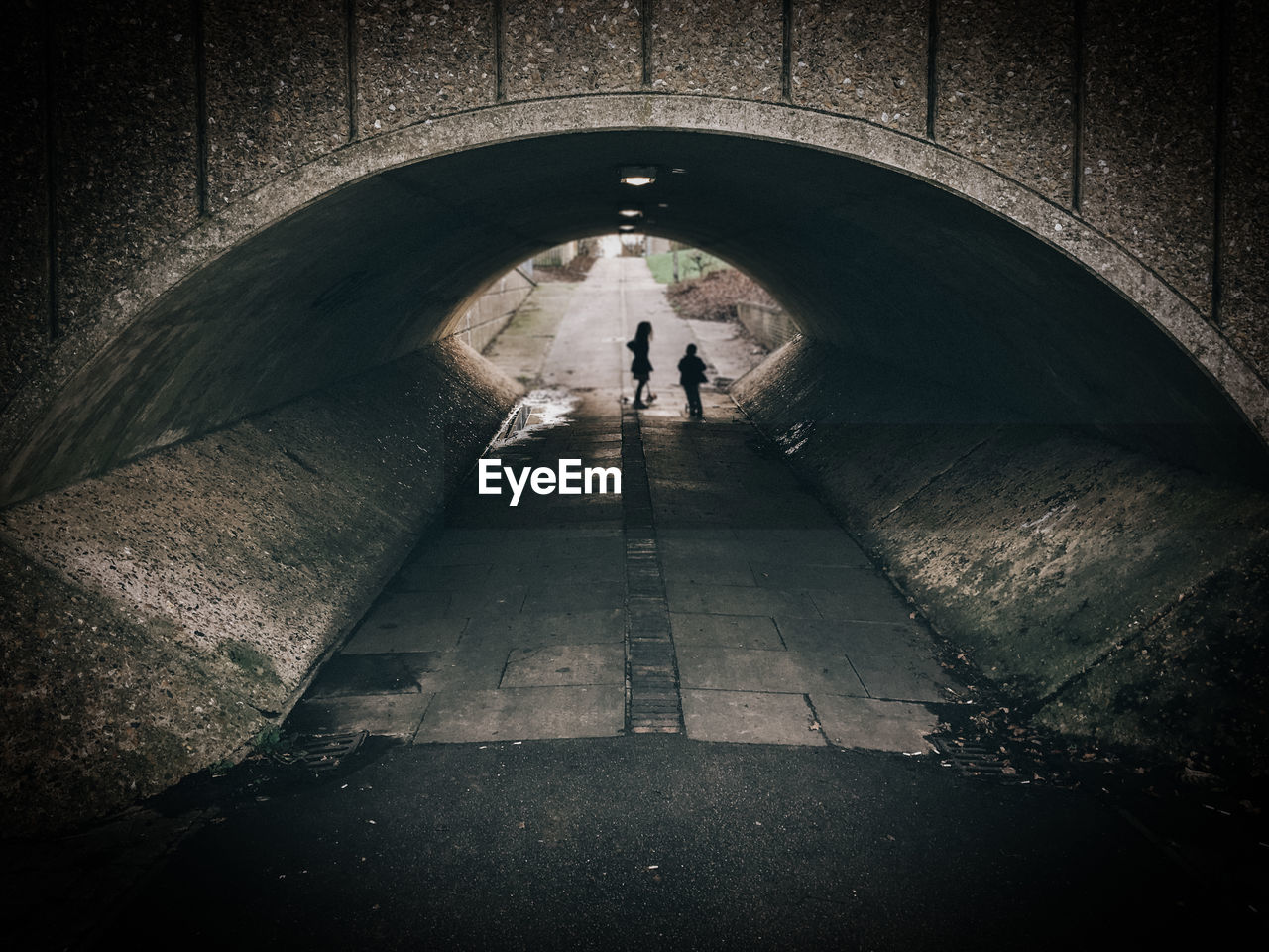 People standing in tunnel