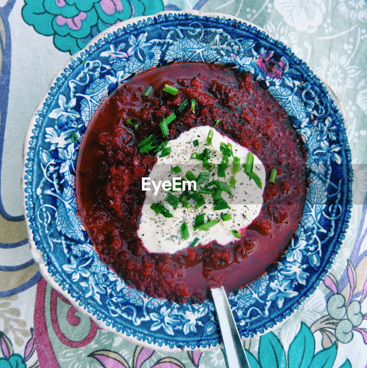 Directly above view of beet soup with sour cream in bowl