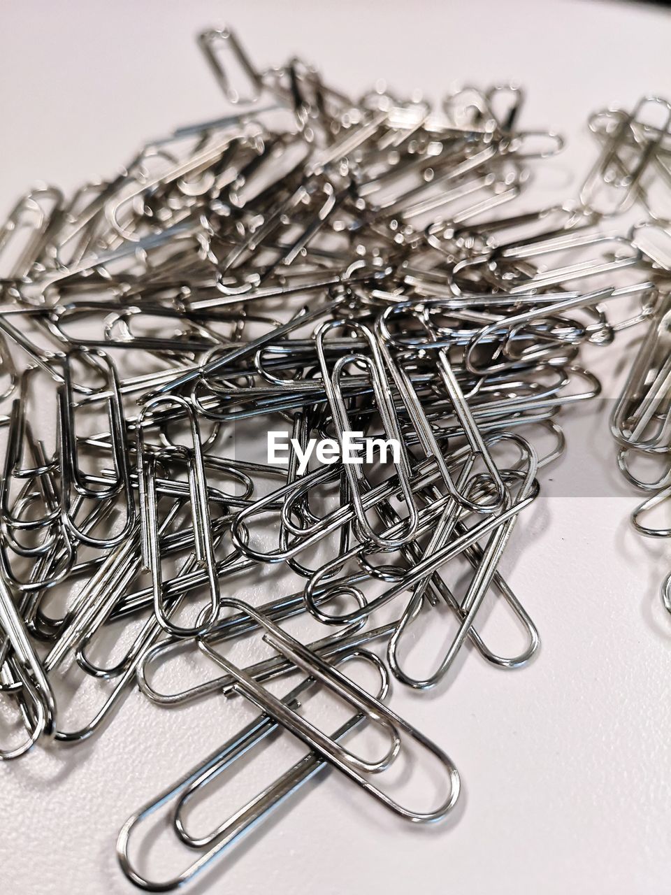 High angle view of paper clips on gray background