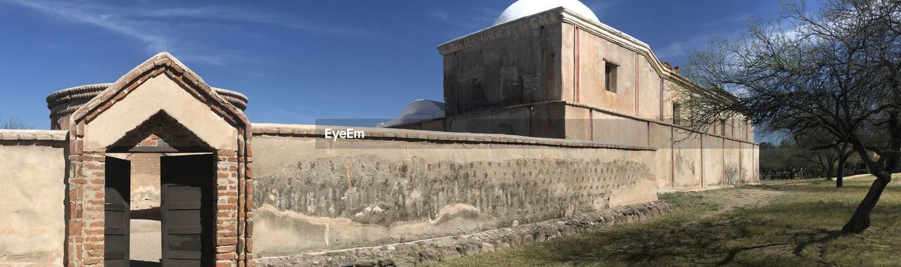 OLD BUILDINGS AGAINST SKY