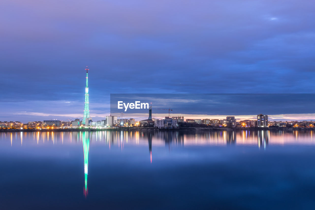 Long exposure photo of a beautiful sunset at lacul morii lake with urban buildings in the background