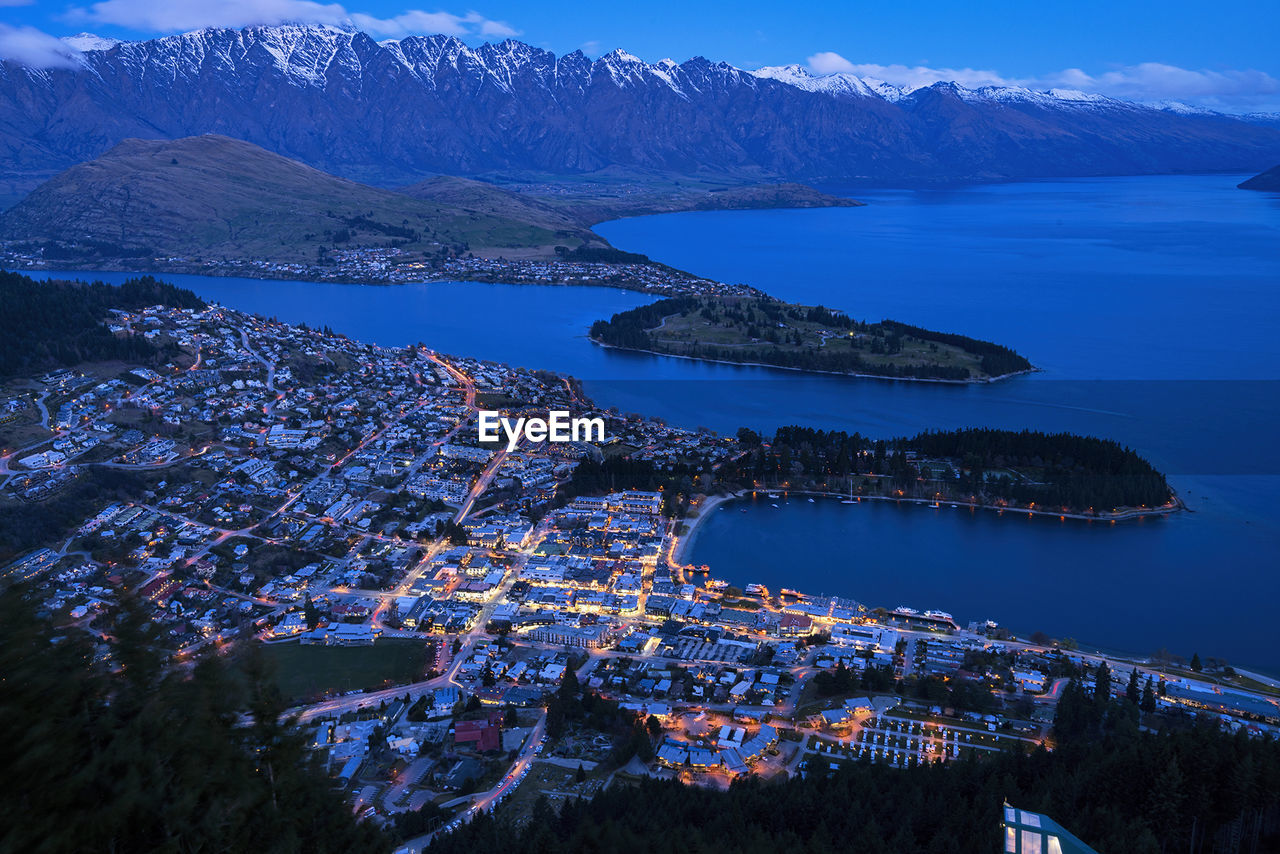 Aerial view of town by sea against sky in queenstown