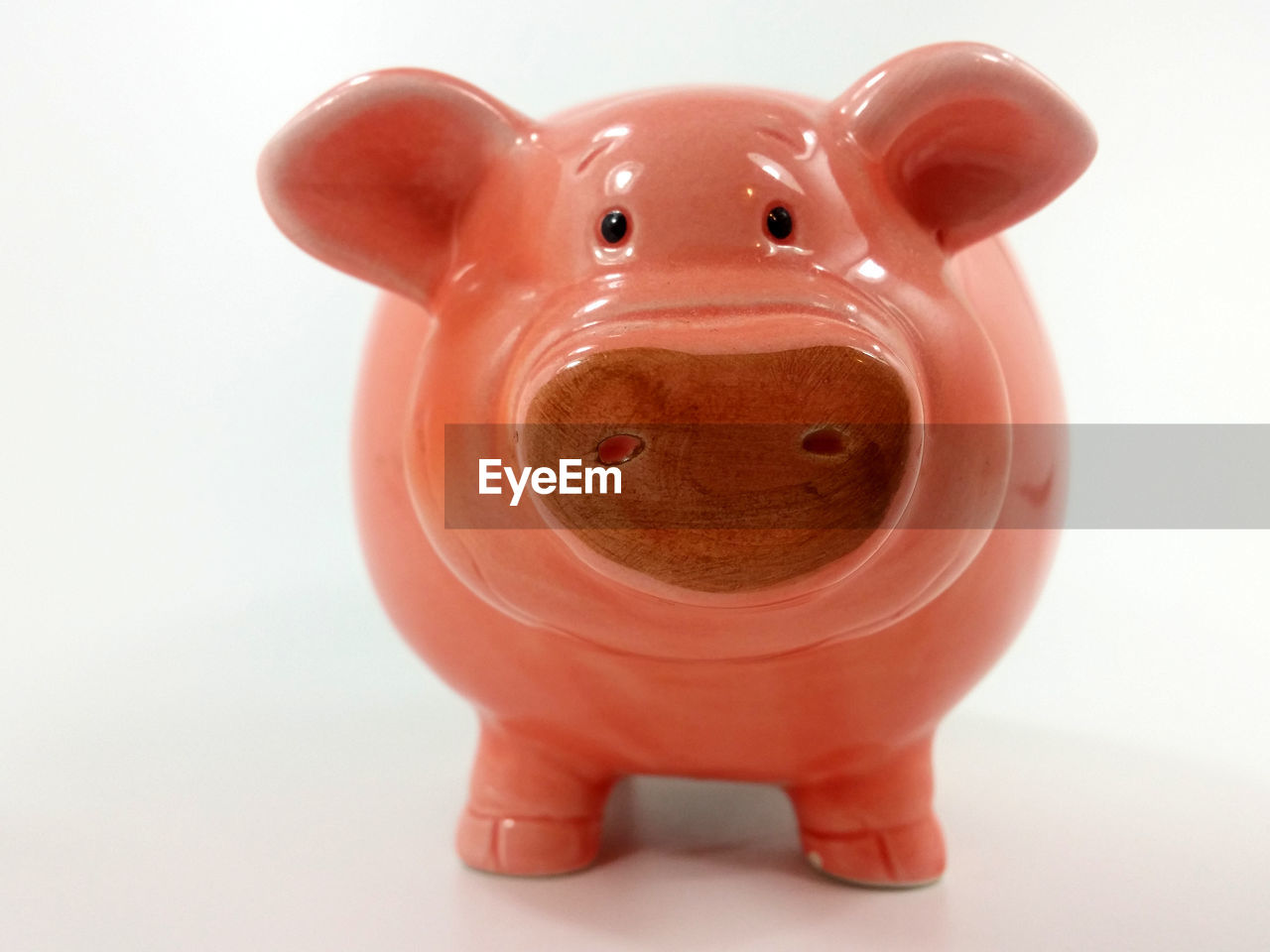 Close-up of piggy bank over white background