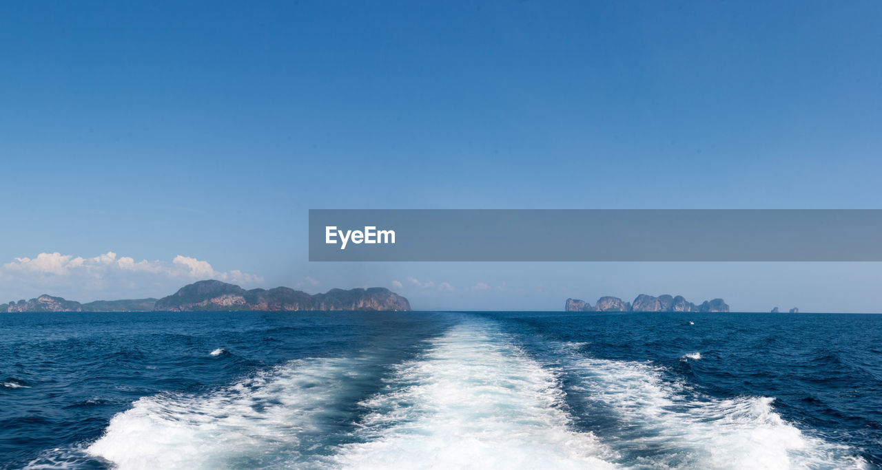 PANORAMIC SHOT OF SEA AGAINST CLEAR BLUE SKY