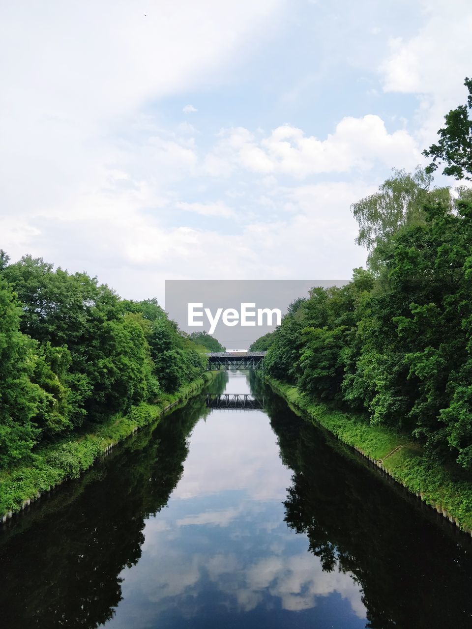 River amidst trees against sky