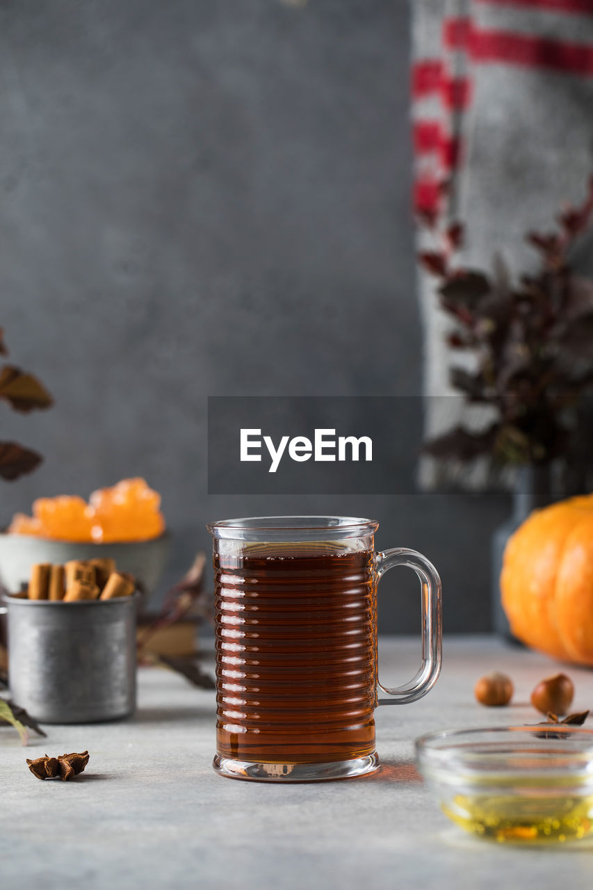 Delicious aromatic warming tea in a glass mug. autumn still life