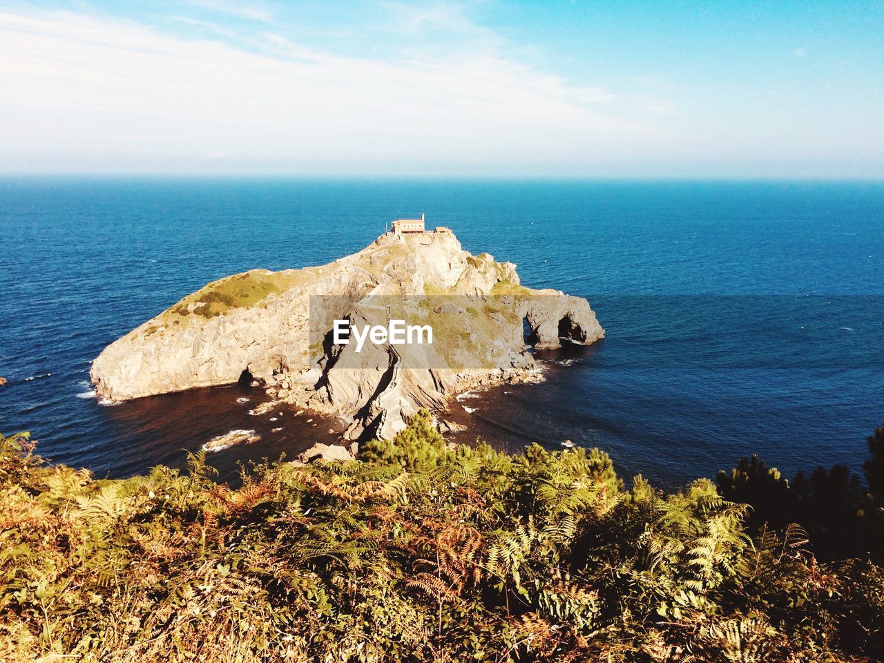 Scenic view of rocks in sea against sky