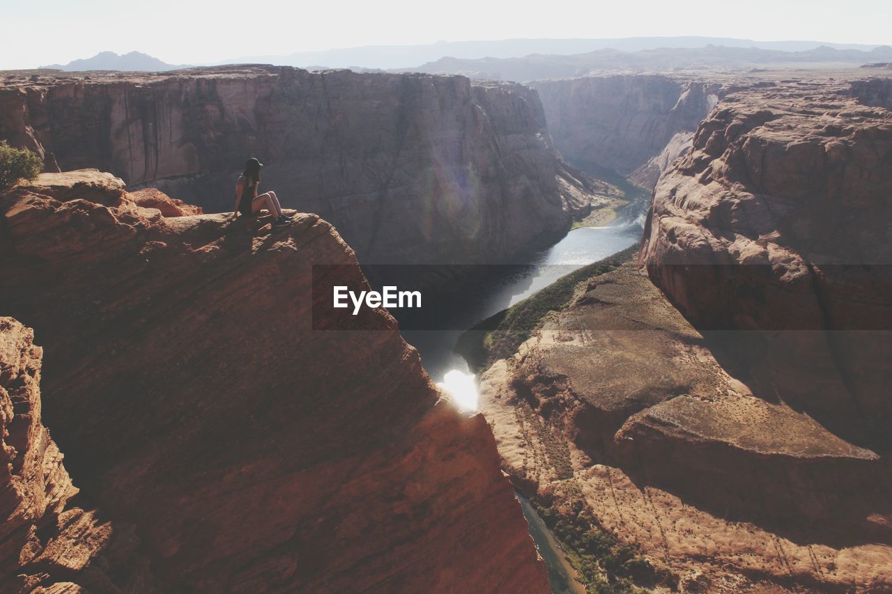 Scenic view of woman sitting atop grand canyon national park