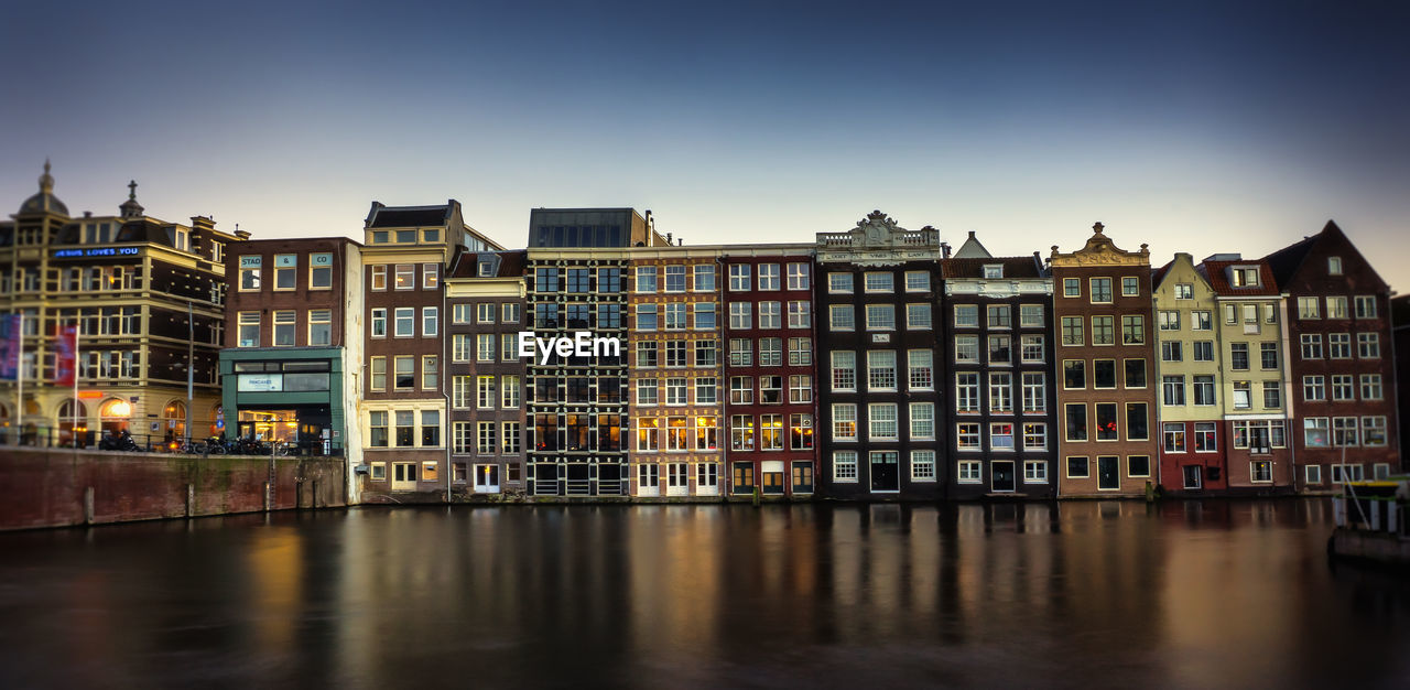 Buildings in city against blue sky