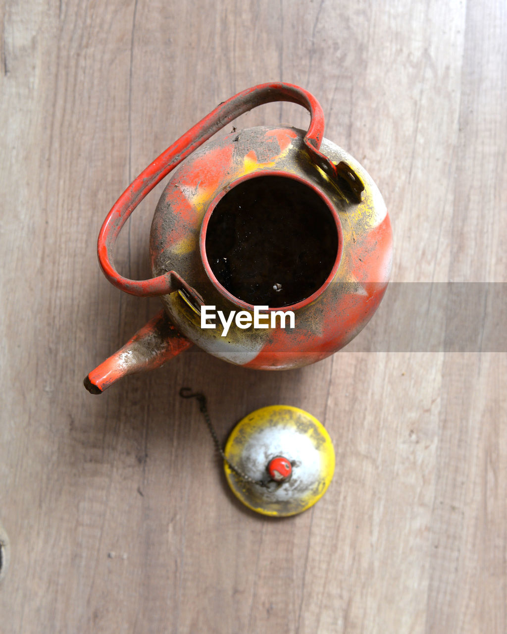 Close-up of weathered teapot on table