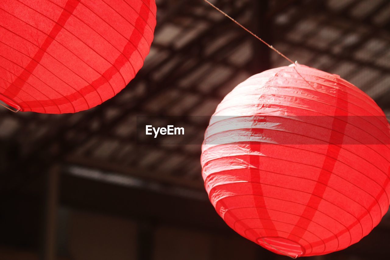 Low angle view of illuminated lanterns hanging from ceiling