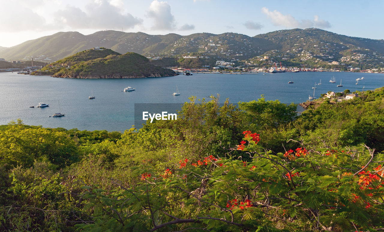 Scenic view of sea and mountains against sky