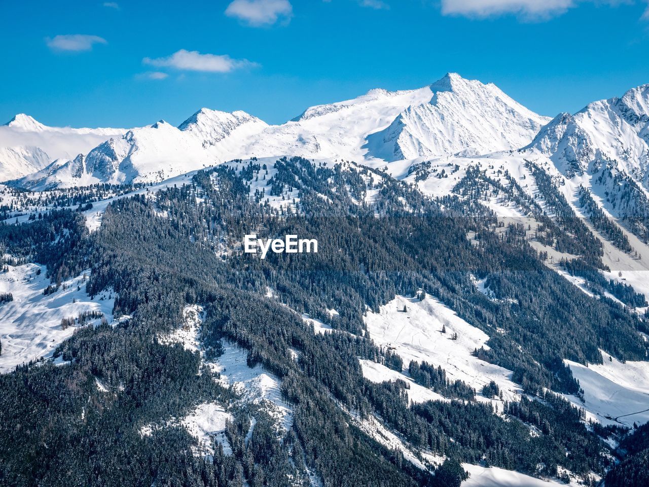 SNOW COVERED MOUNTAINS AGAINST SKY