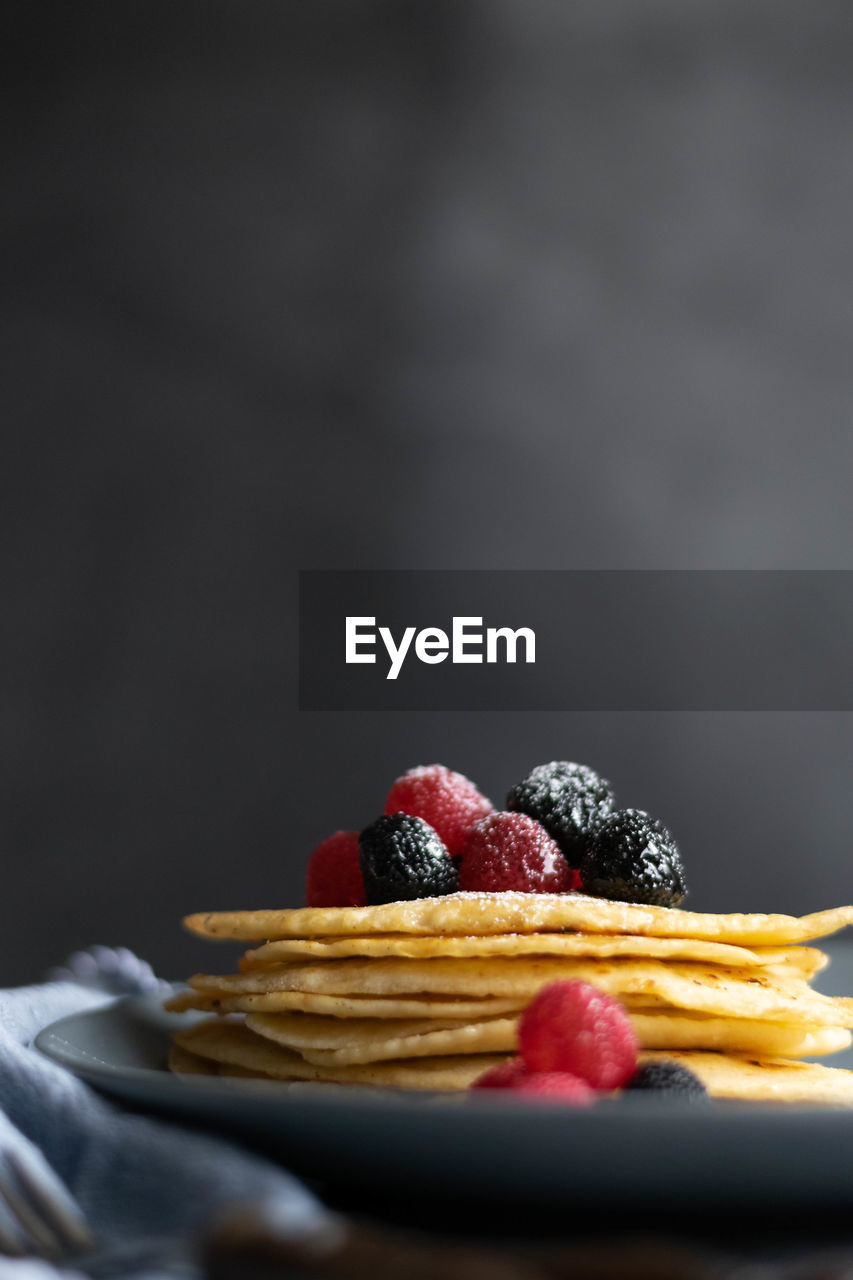 Homemade crepes on table, dark food photography, space for text