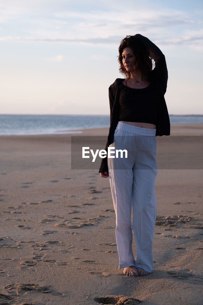 Young woman standing at beach