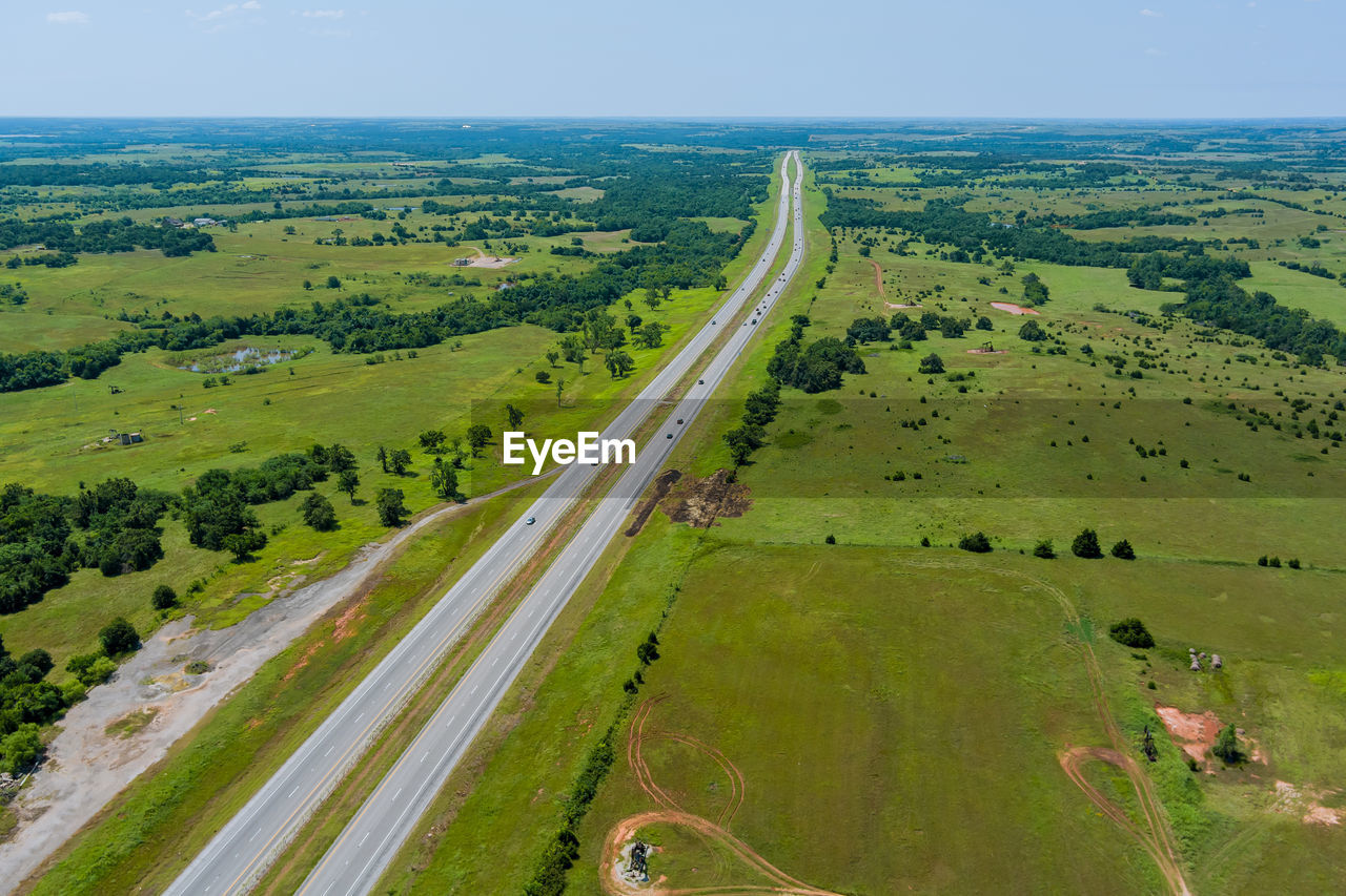 PANORAMIC VIEW OF ROAD AMIDST LAND AGAINST SKY