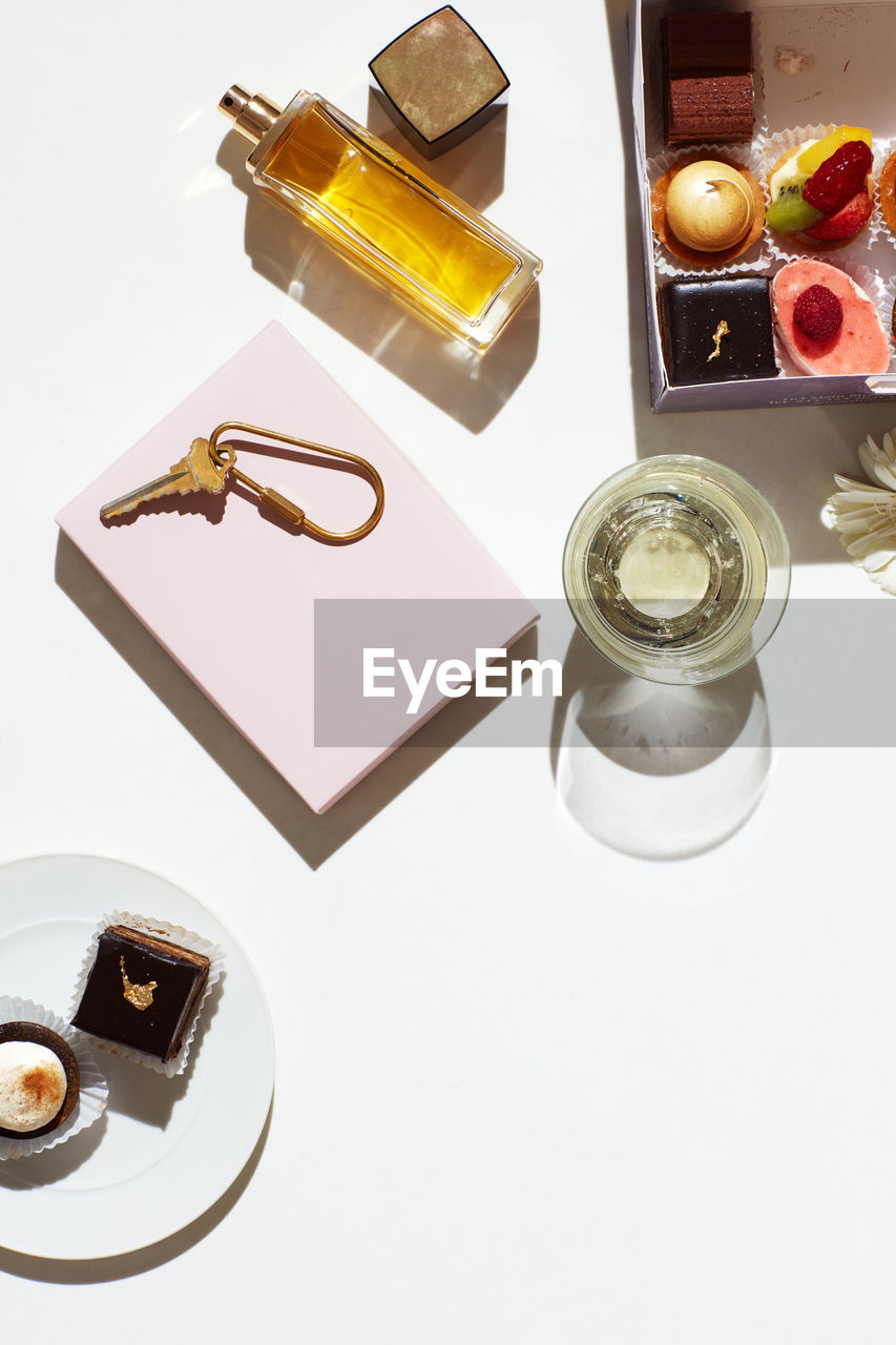 Overhead still life of chocolates, perfume, accessories