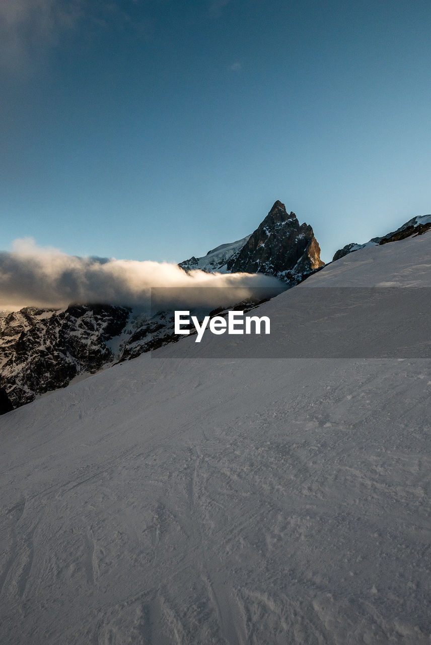 Scenic view of snowcapped mountains against clear sky