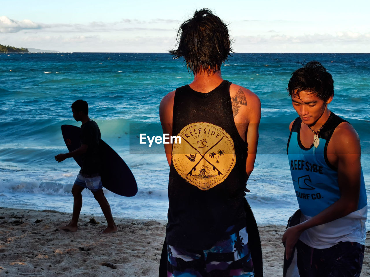 PEOPLE ON BEACH AGAINST SEA