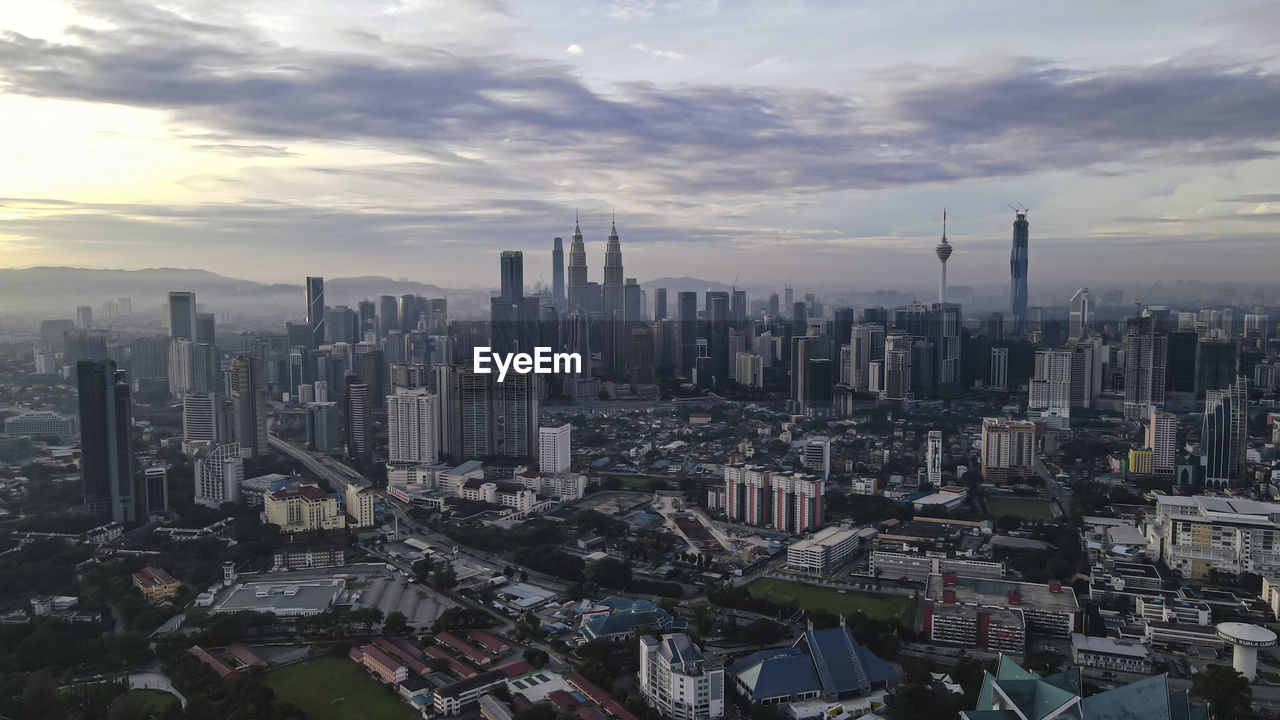 Aerial view of kuala lumpur, malaysia under early morning sun with slight haze. 