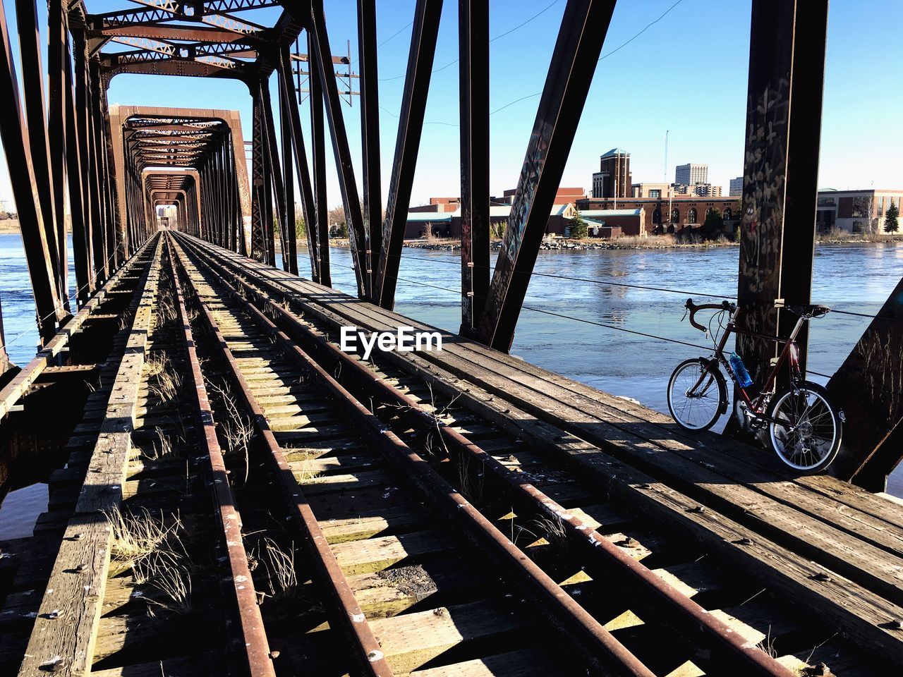 BICYCLE BRIDGE OVER CITY AGAINST SKY