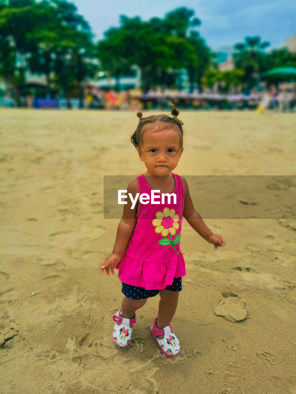 Portrait of cute baby girl on beach