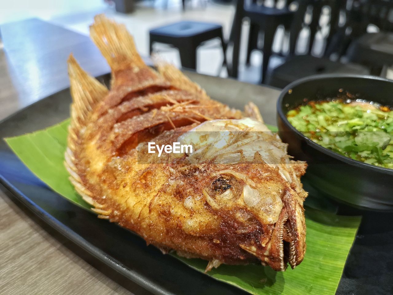 HIGH ANGLE VIEW OF FISH SERVED IN PLATE ON TABLE