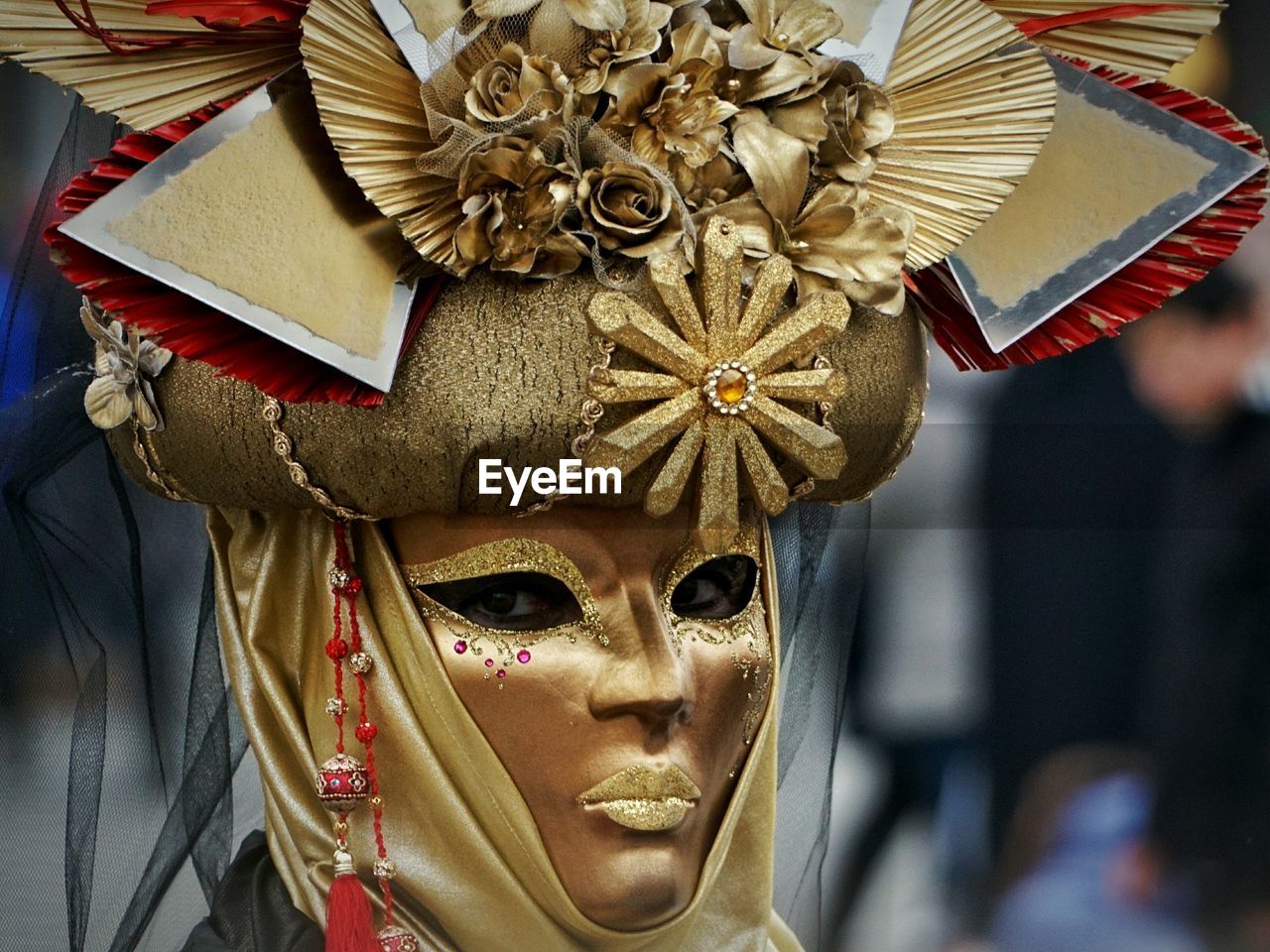 Close-up portrait of woman wearing carnival mask