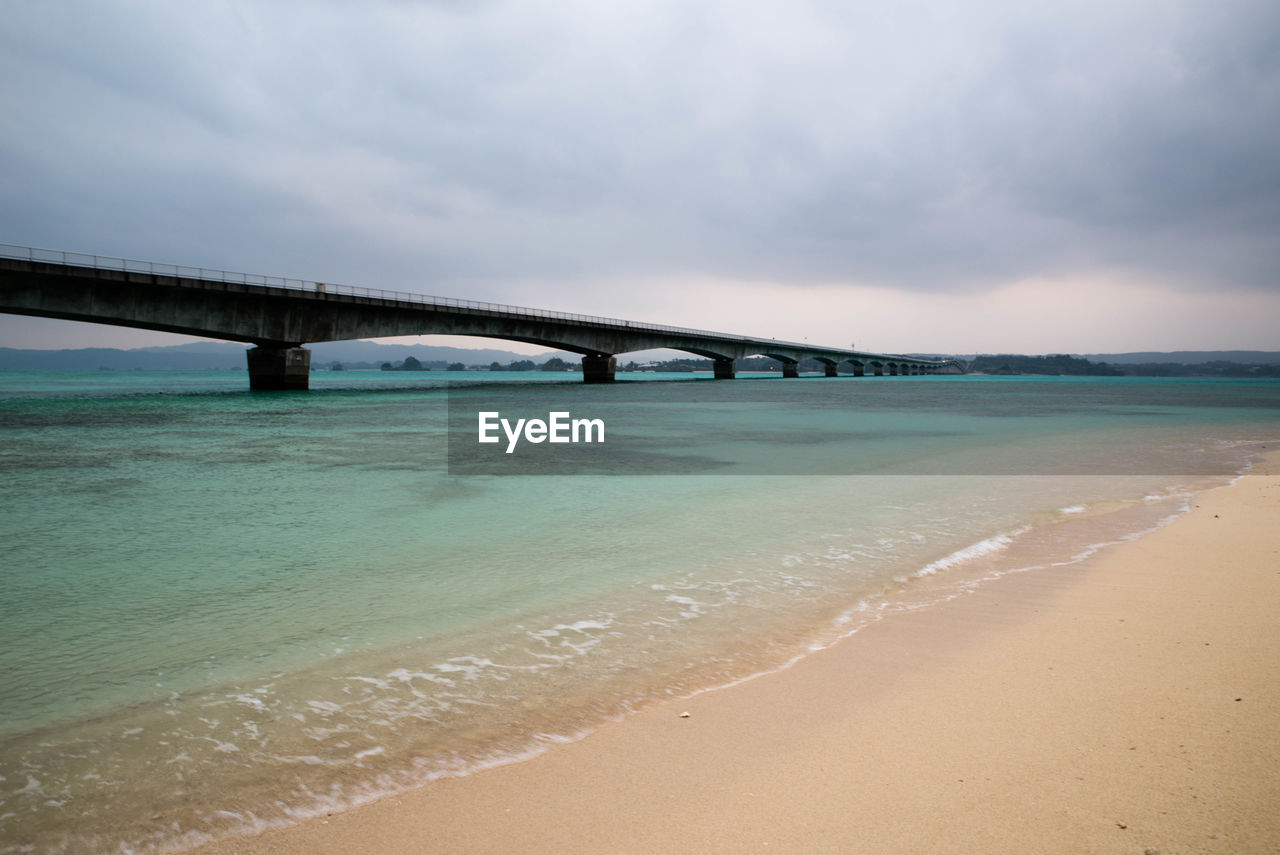 Bridge over sea against sky