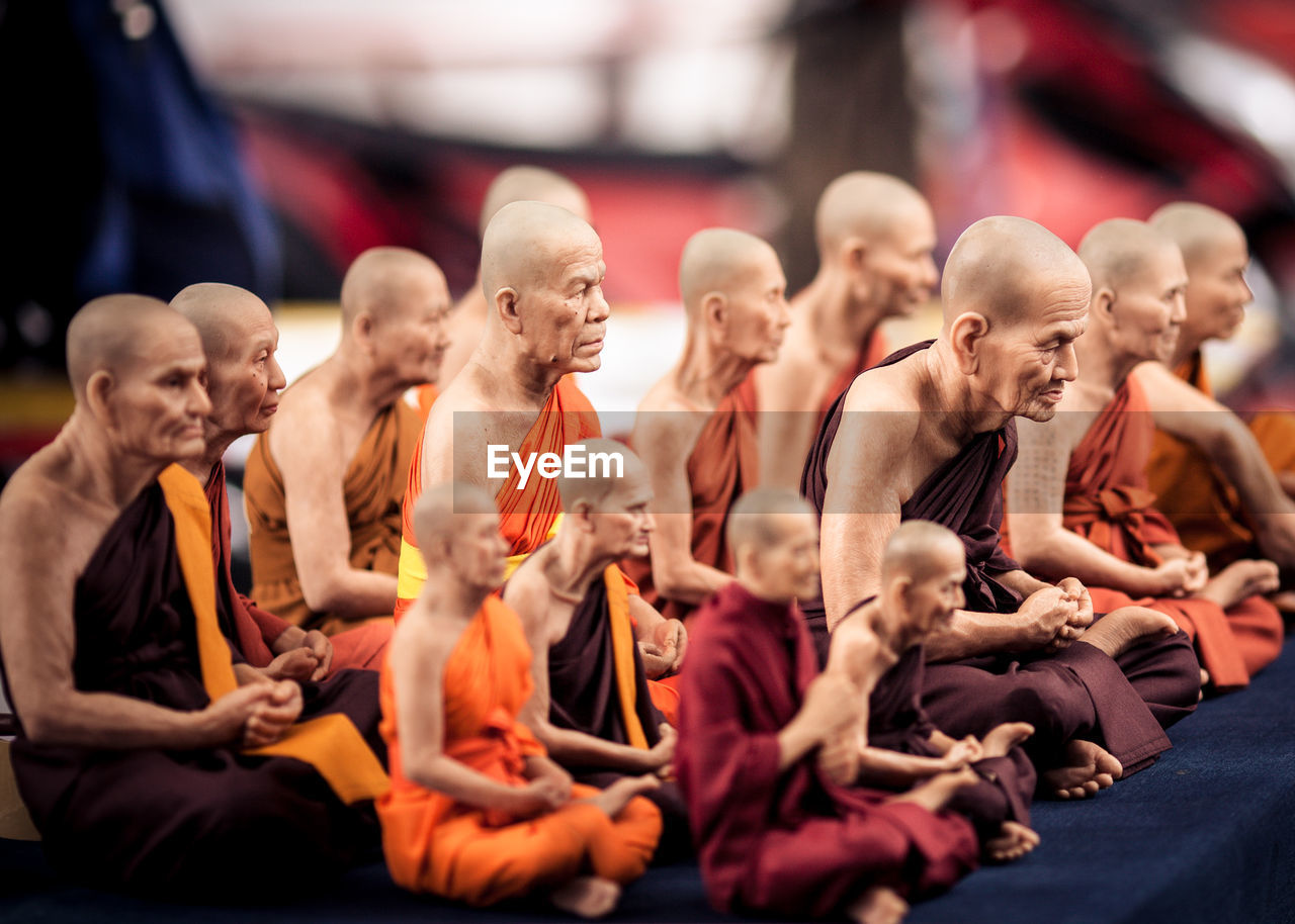 Digital composite image of monks sitting