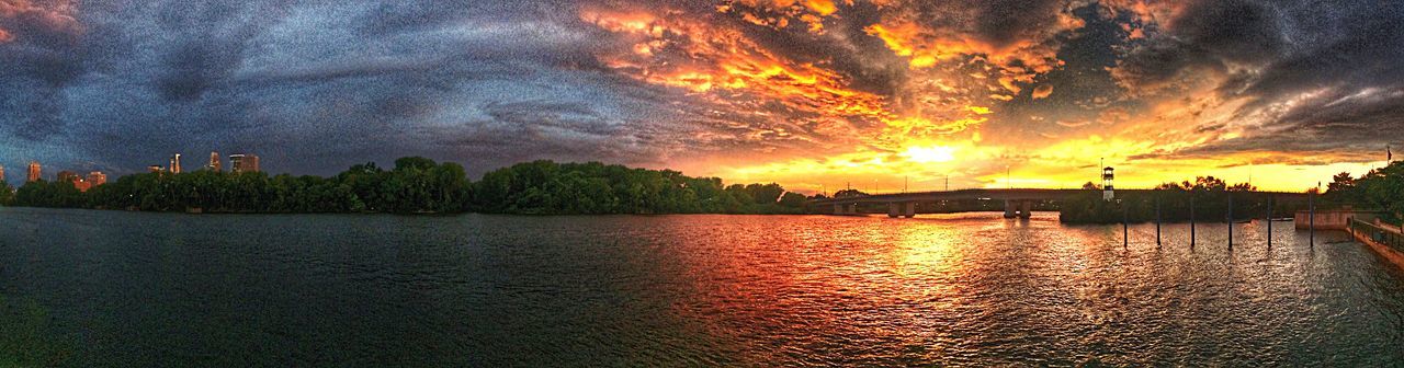 sunset, tree, water, cloud - sky, sky, nature, beauty in nature, scenics, dramatic sky, outdoors, tranquility, river, reflection, tranquil scene, no people, travel destinations, nautical vessel, building exterior, city, architecture, day