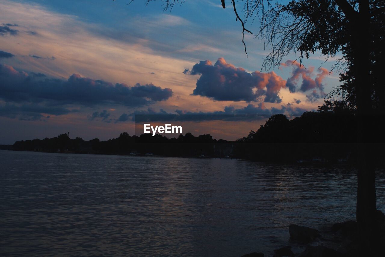 Scenic view of lake against sky during sunset