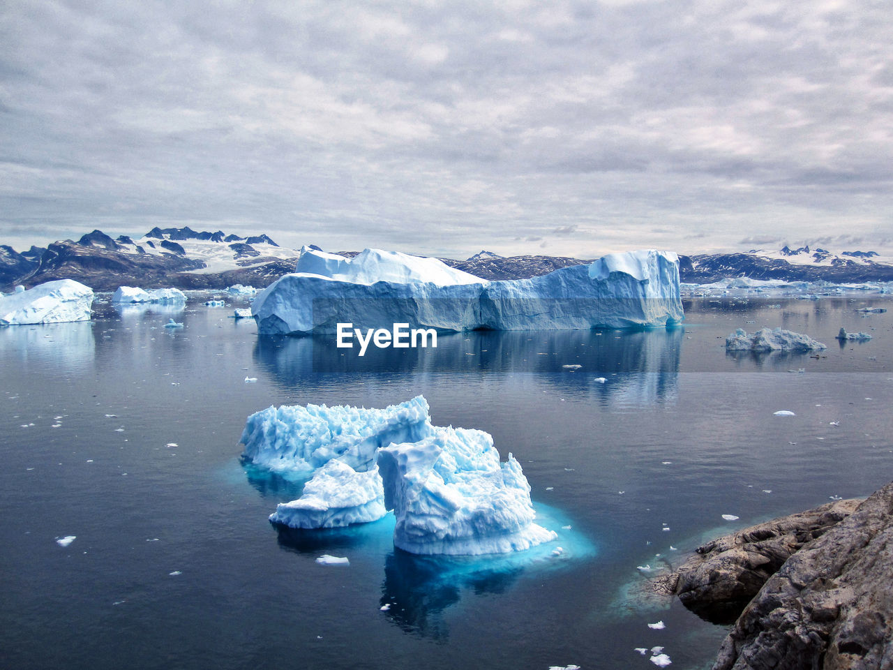 Glaciers in lake against sky