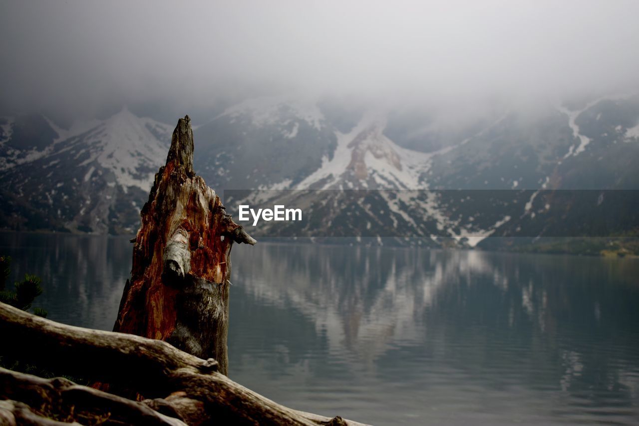 SCENIC VIEW OF LAKE AGAINST SNOWCAPPED MOUNTAINS