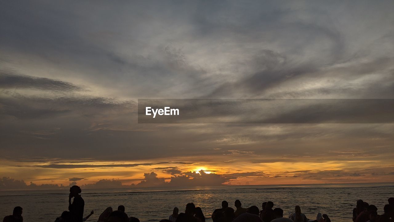 SILHOUETTE PEOPLE ON BEACH DURING SUNSET