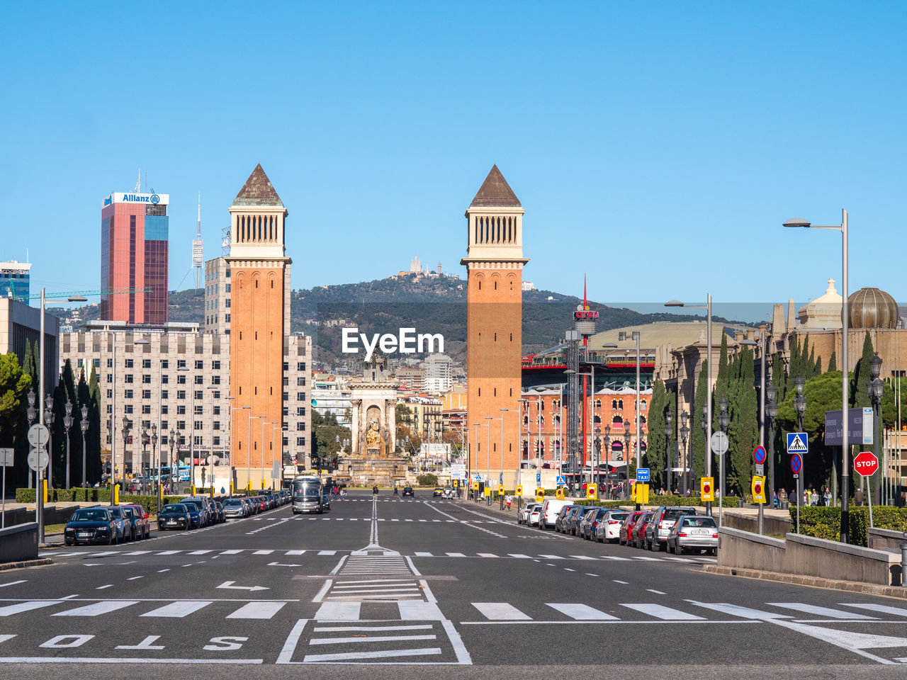 CITY STREET BY BUILDINGS AGAINST CLEAR SKY