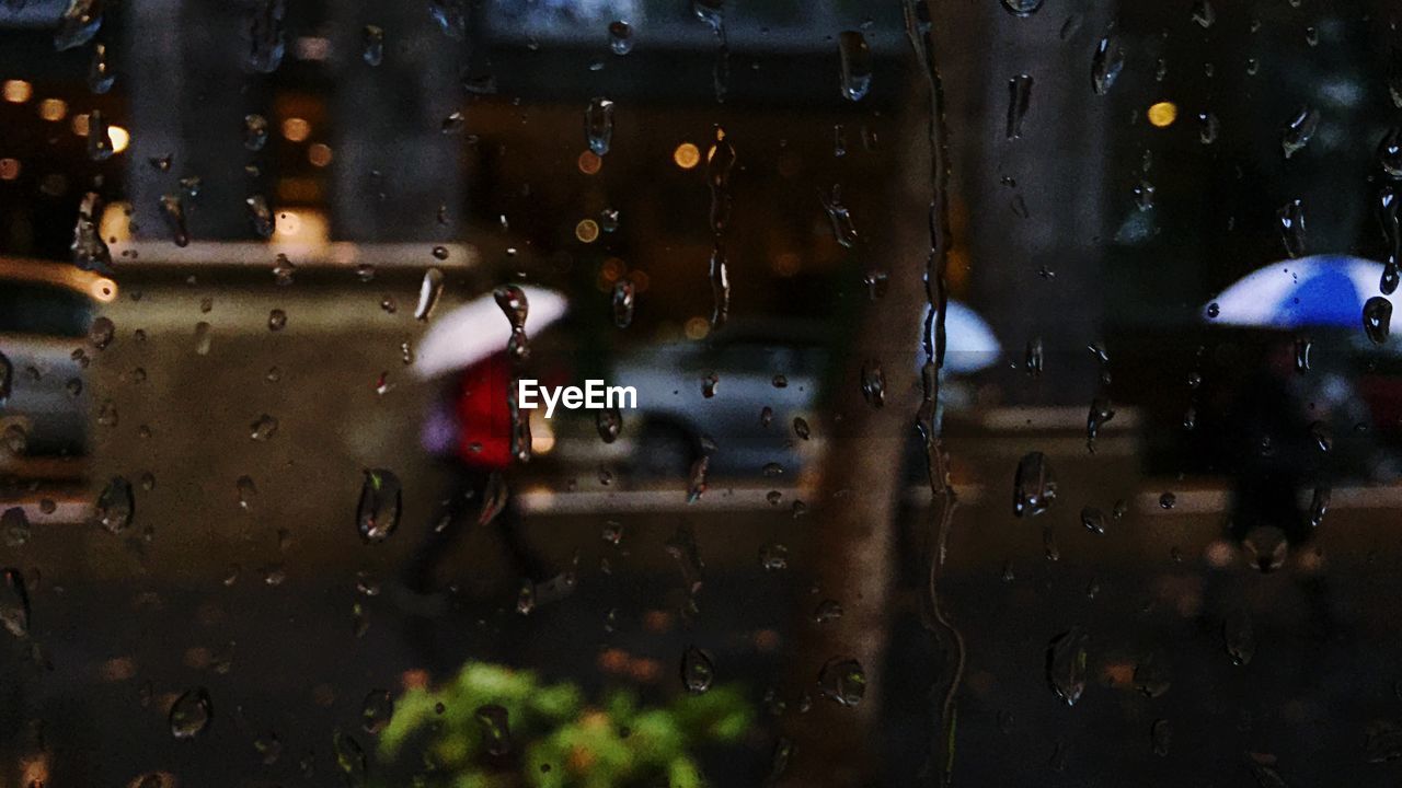 Street seen through wet window during monsoon