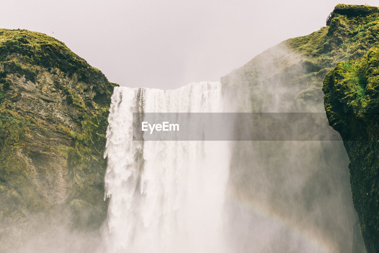 Low angle view of waterfall against sky