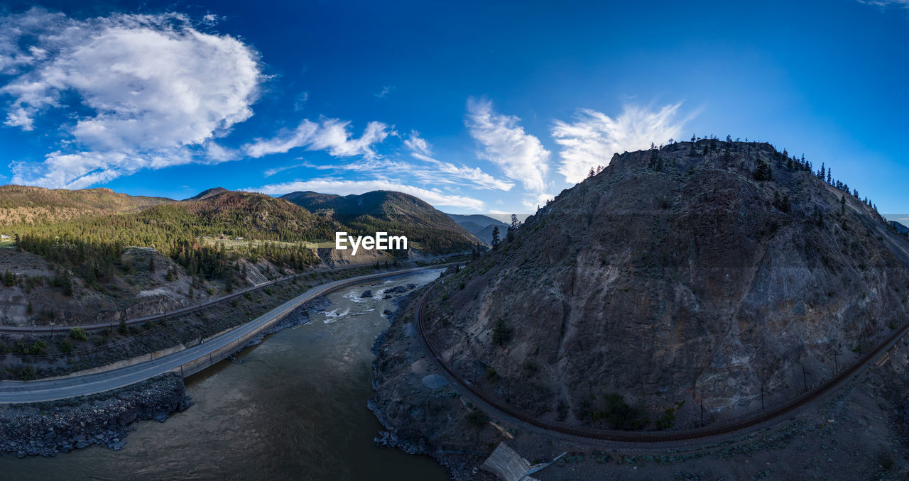 sky, landscape, mountain, environment, cloud, scenics - nature, nature, mountain range, beauty in nature, blue, travel, travel destinations, land, panoramic, no people, water, outdoors, road, transportation, tranquility, tourism, non-urban scene, architecture, rock, tranquil scene, plant, mountain pass, day