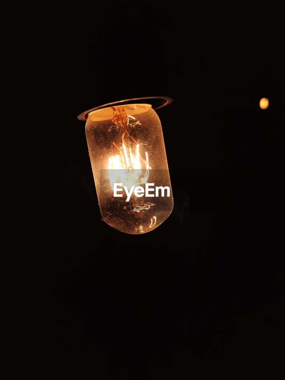 CLOSE-UP OF ILLUMINATED LIGHT BULB