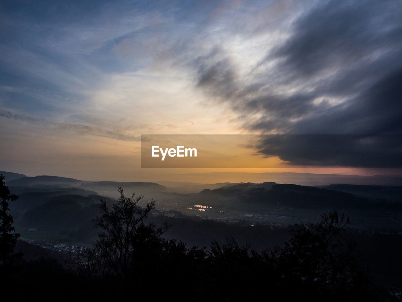 Scenic view of landscape against sky at sunset