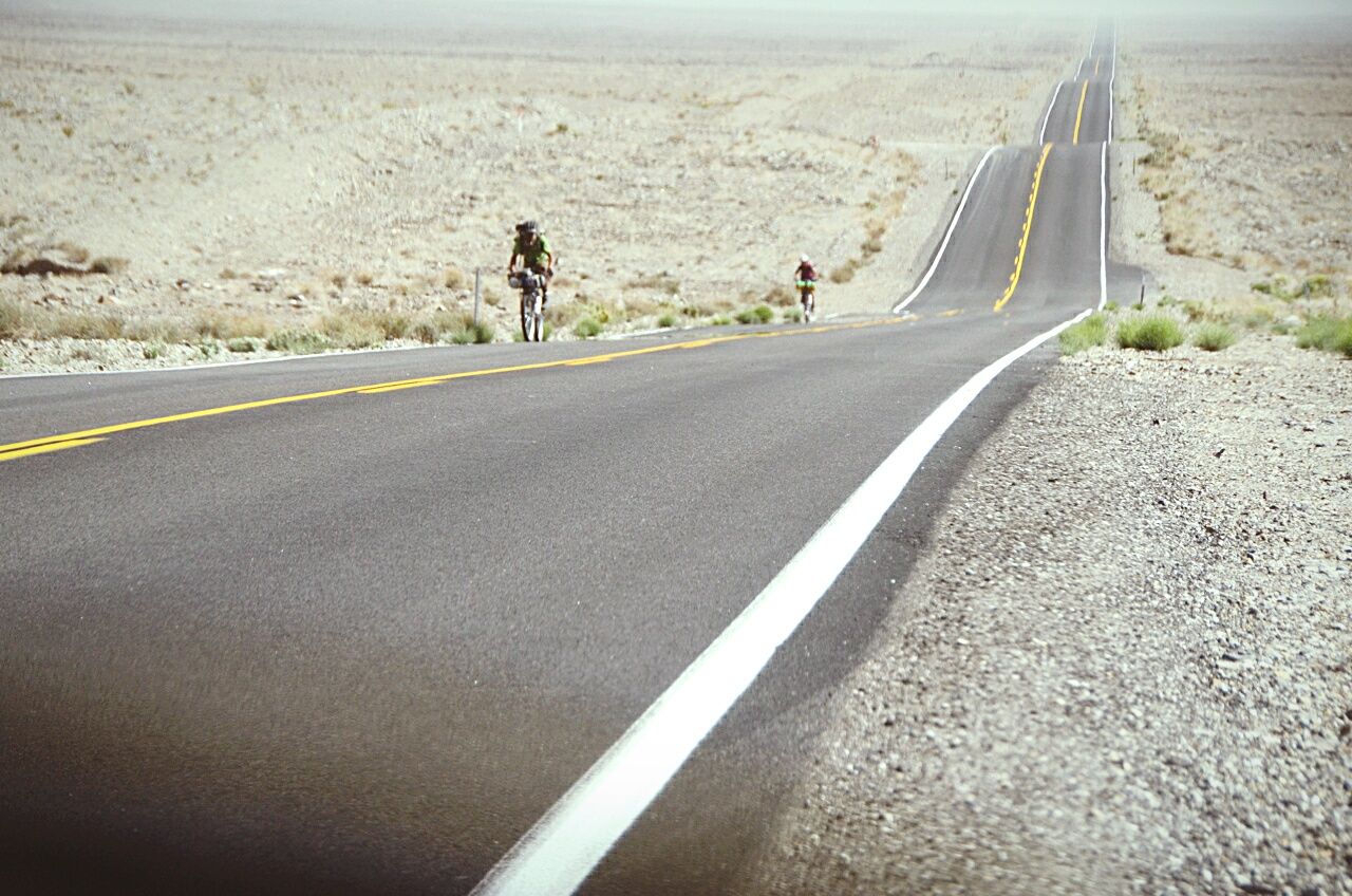 Two cyclists on desert road