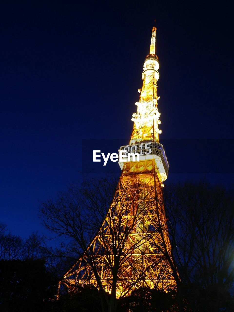 Low angle view of tokyo tower lit up at night