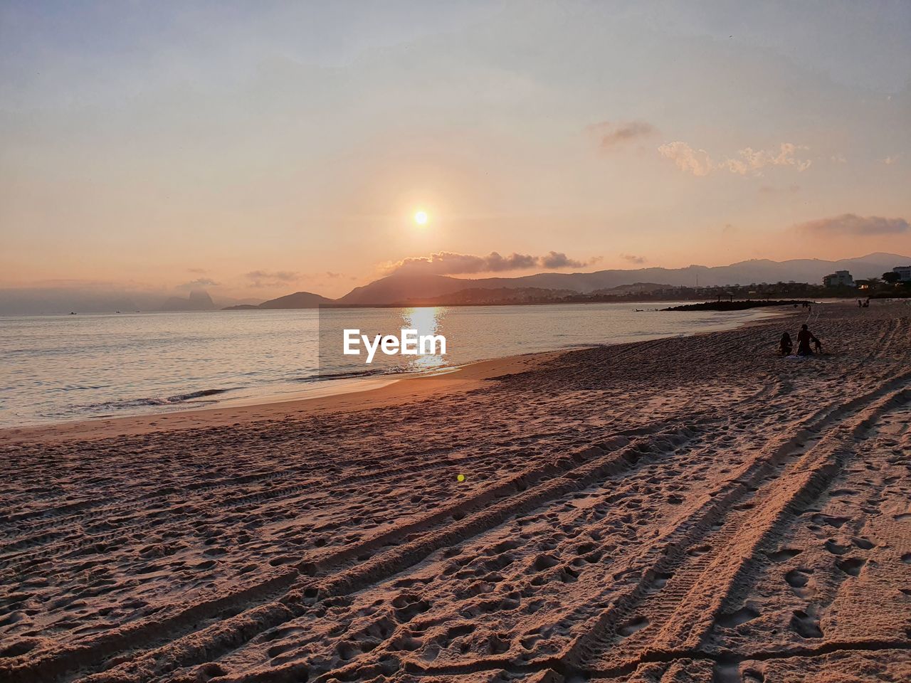 SCENIC VIEW OF BEACH DURING SUNSET